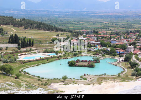 An elevated view over the UNESCO World Heritage site, with the town and pond lake below  Pamukkale, Hierapolis Turkey. Stock Photo