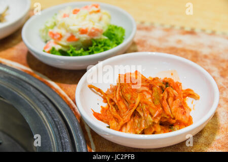 Kimchi korea food on the table beside  barbecue stove Stock Photo