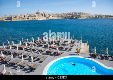 Skyline of Valetta, capital of Malta, dome of the Carmelite church and steeple of St. Paul's Anglican Pro Cathedral Church, restaurant terrace in Slie Stock Photo