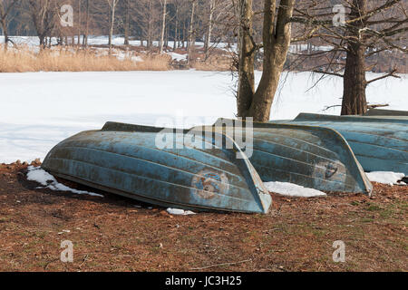 inverted boats on the frozen lake Stock Photo