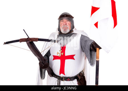 Knight Templar posing with crossbow and flag isolated in white Stock Photo