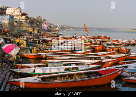 Many colorful rowing boats are tight up at Dashashwamedh Ghat, Main Ghat, in the suburb Godowlia at the holy river Ganges Stock Photo