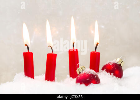 Four burning red candls with christmas ball Stock Photo