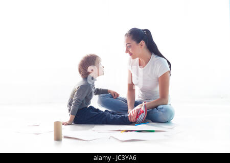 mother and young son painted pencils learn to draw Stock Photo