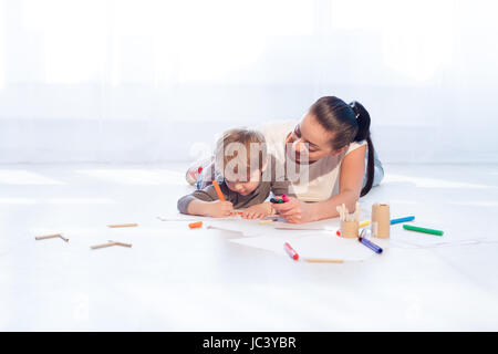 mother and young son painted pencils learn to draw Stock Photo