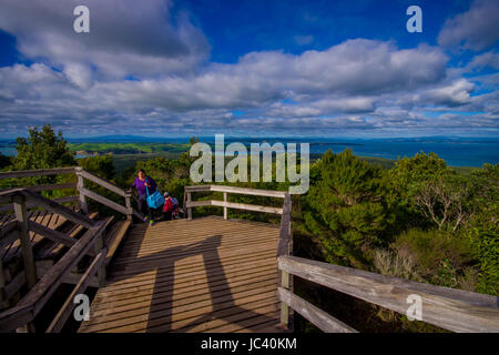 AUCKLAND, NEW ZEALAND- MAY 12, 2017: Unidentified people enjoying the beautiful view from top in the mountain in Rangitoto Island walking in wooden pa Stock Photo