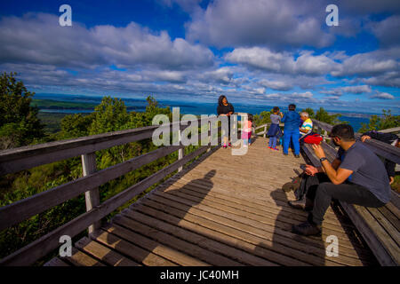 AUCKLAND, NEW ZEALAND- MAY 12, 2017: Unidentified people enjoying the beautiful view from top in the mountain in Rangitoto Island walking in wooden pa Stock Photo