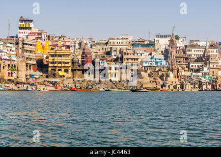 Panoramic view across the holy river Ganges on Manikarnika Ghat, Burning Ghat, in the suburb Godowlia Stock Photo