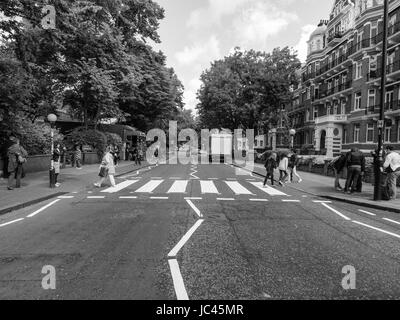 LONDON, ENGLAND, UK - JUNE 18: People crossing the Abbey Road zebra crossing made famous by the 1969 Beatles album cover on June 18, 2011 in London, England, UK Stock Photo