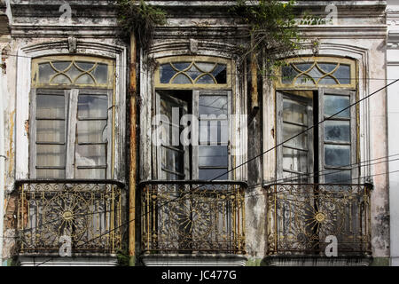 View of windows in a ruined house facade in Cachoeira, a colonial city in Bahia, Brazil Stock Photo