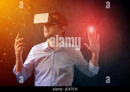 Businessman with VR goggles headset exploring virtual reality immersive technology content Stock Photo