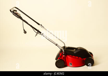 Lawnmower Isolated on White Background. Gas Lawn Mower. Red Grass-Cutter. Garden Equipment. Garden Power Tools. Stock Photo