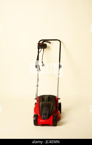 Lawnmower Isolated on White Background. Gas Lawn Mower. Red Grass-Cutter. Garden Equipment. Garden Power Tools. Stock Photo