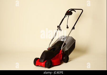 Lawnmower Isolated on White Background. Gas Lawn Mower. Red Grass-Cutter. Garden Equipment. Garden Power Tools. Stock Photo