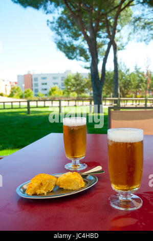 Two glasses of beer and Spanish omelet in a terrace. Spain. Stock Photo
