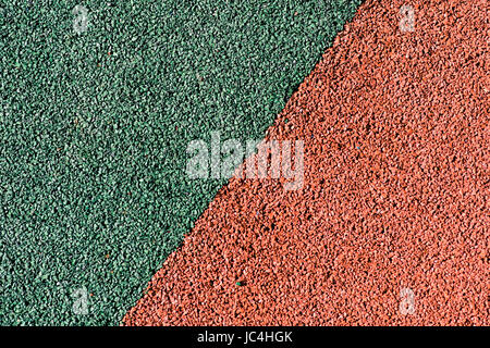 Rubber colored safety coating of sports playground closeup background Stock Photo