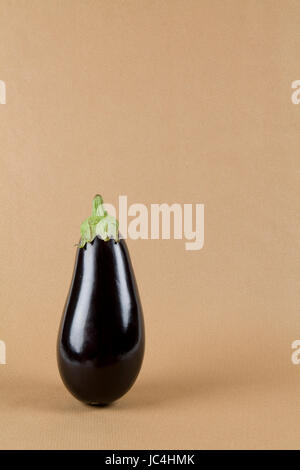 Minimal still life photography. Eggplant isolated on a kraft paper Stock Photo