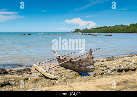 Traditional pirogue on the shore of Nosy Be island in Madagascar, Africa. Focus on the foreground. Stock Photo