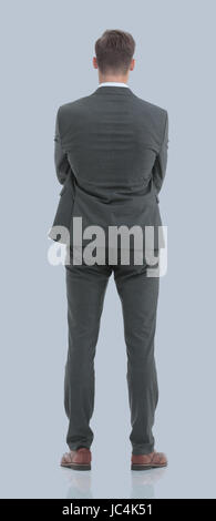 Businessman from the back - looking at something over a gray bac Stock Photo