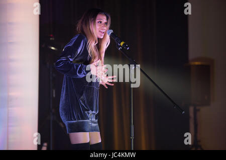 a young woman singing Stock Photo