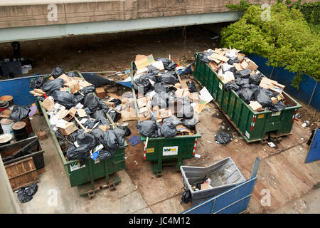 full overflowing commercial waste dumpsters Philadelphia USA Stock Photo