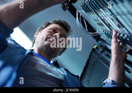 Nice serious man working in the data center Stock Photo