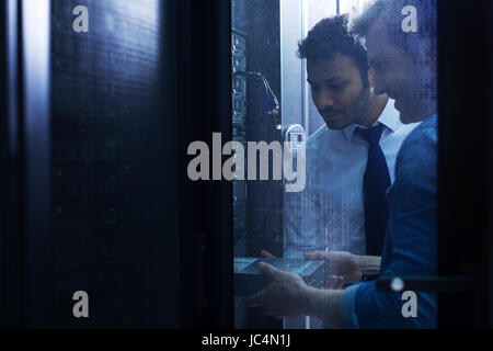 Handsome male technicians working in the server room Stock Photo