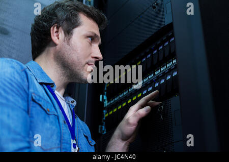 Handsome serious man looking at the control panel Stock Photo