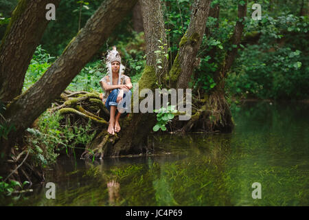 little funny boy playing native american Stock Photo