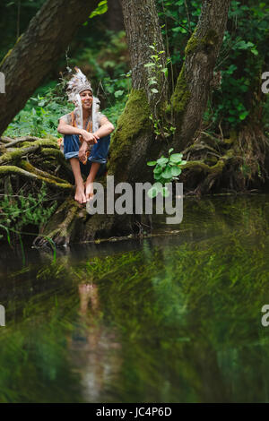 little funny boy playing native american Stock Photo