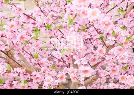 Artificial Sakura Flowers or Cherry Blossoms in Japanese Style for Home and Building Decoration. Soft Focus in Vintage Color Toned. Stock Photo