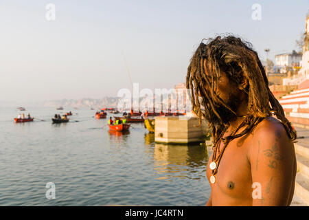 A Sadhu, holy man, is sitting and praying on a platform at the holy river Ganges at Meer Ghat in the suburb Godowlia Stock Photo