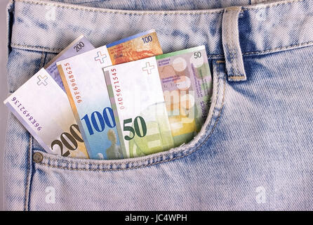 Closeup of the swiss notes in the jeans pocket Stock Photo