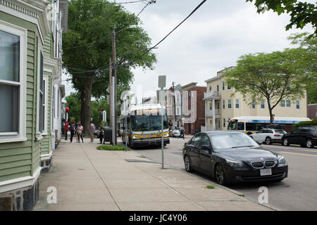 A city bus makes a stop in South Boston in Boston, Massachusetts Stock Photo