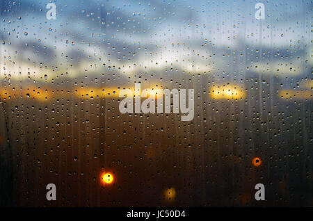 Raindrops on a window at sunset Stock Photo