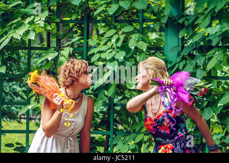Two girlfriends are having fun in the city park. Joyfull weekend. Stock Photo