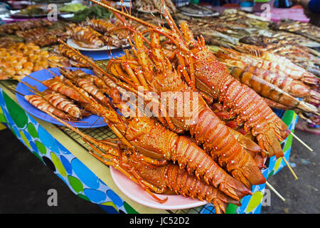 Grilled lobster and other seafood at Kota Kinabalu night market. Stock Photo