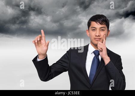 Composite image of thoughtful businessman touching Stock Photo