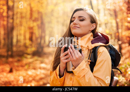 Smiling female hiker has a break for hot drink Stock Photo