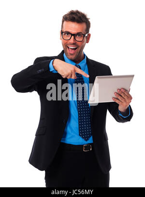 Shocked businessman showing on digital tablet Stock Photo