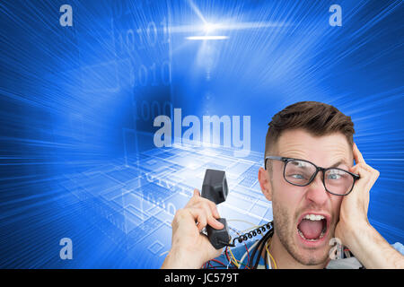 Composite image of portrait of frustrated computer engineer screaming while on call in front of open cpu Stock Photo