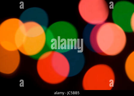 Bokeh of colorful party lights in red, orange and green for a festive background for a celebration or holiday Stock Photo