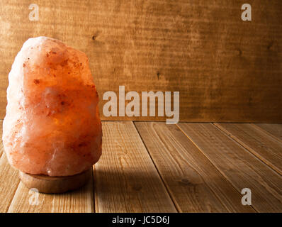 Himalayan salt lamp on wooden background Stock Photo