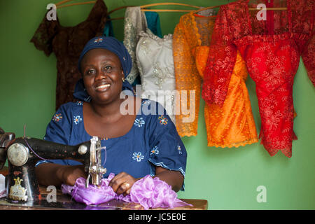 A female tailor at work at her sewing machine, Nigeria Africa Stock Photo