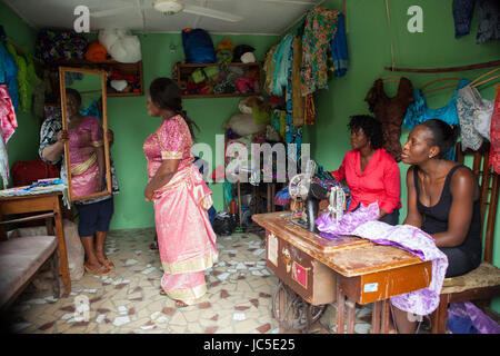 A woman tries on a dress in a local tailors, Nigeria, Africa Stock Photo