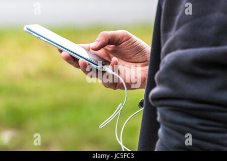 Close-up of a man using mobile phone, smartphone texting, mobile data, chat, using communication with friends information technology, internet Stock Photo