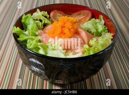 Japanese Cuisine, White Steamed Rice Topping with Fresh Salmon, Tomatoes and Green Lettuce in Donburi Bowl. Stock Photo