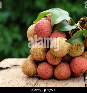 Vietnam fruit, litchi or lychee, a tropical fruits that delicious, sweet at Bac Giang, bunch of vai thieu on green background Stock Photo