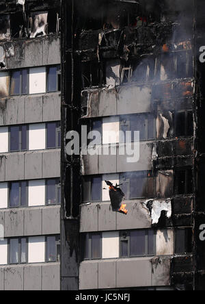 Debris falls from a fire that has engulfed the 24-storey Grenfell Tower in west London. Stock Photo