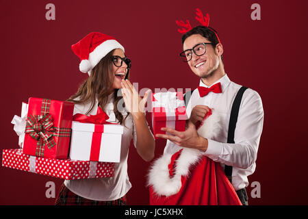 Nerd couple exchanging christmas gifts Stock Photo